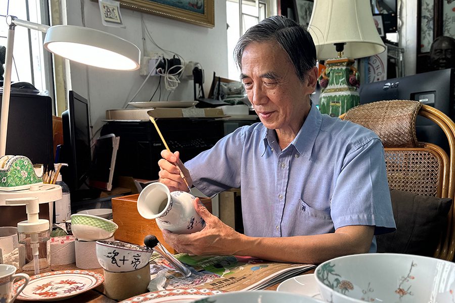 Craftsman drawing patterns on a vase